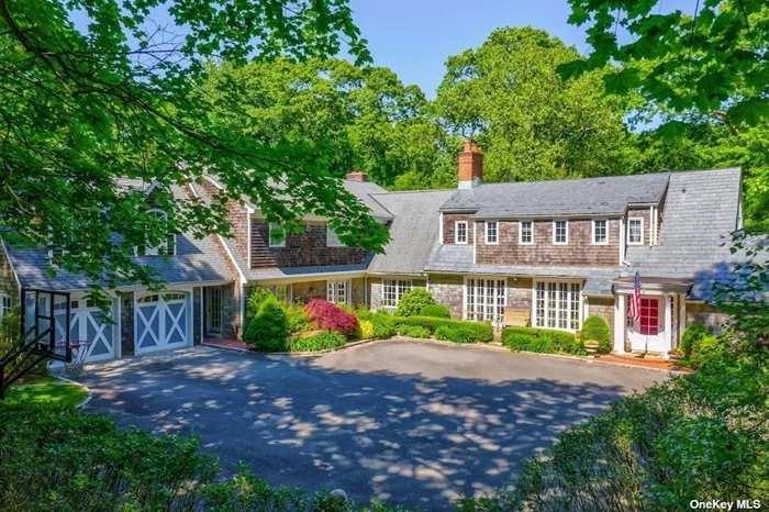 This stunning Hamptons style colonial, located on 2 private acres, offers a perfect blend of elegance and comfort. Spanning more than 5, 700 square feet of living space, the home includes 5 bedrooms, 5.55 bathrooms, a home office and various, gracious living and entertaining spaces. There are two wood burning fireplaces, one with a mantel that came from an estate belonging to the EF Hutton family. The charming kitchen features views of the front and back yards, limestone countertops, and high-end appliances. There is a separate fully equipped prep kitchen, perfect for hosting parties or family gatherings. The first floor also includes a bedroom with an adjacent full bathroom and direct access to the backyard.  On the second floor, the spacious master bedroom suite boasts two en-suite bathrooms (one with steam shower), a walk-in-closet and a large bonus room currently used as a home gym. The second floor contains three additional bedrooms, two full bathrooms and two bonus spaces.  Multiple French doors connect the interior to the meticulously maintained outdoor spaces. The beautifully landscaped yard features an in-ground heated pool, a brick and bluestone patio, a vegetable garden and extensive mature plantings. There is a two-car garage that is also accessible from the back of the house. Showings begin Saturday July 15th.