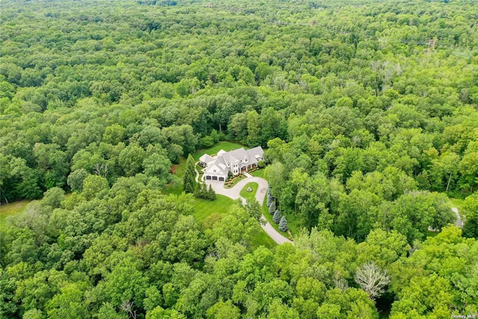 A truly unique country Estate. Designed and constructed by a custom builder to be used as his personal primary residence, no expense was spared in design or building materials. The home boasts an impeccable fusion of commercial-grade fixtures, state of the art construction and exacting architectural detail, culminating in a house that strikes a perfect balance of bold, warmth and welcoming. The Estate is nestled on 15 serene, wild-game filled, wooded acres, surrounded by an additional 150 acres of protected nature preserve. This 5 bedroom, 5.5 bath home is as luxurious as the location is secluded and lush. The drive along the winding, manicured, private road through the beautiful hand-crafted gate to the home is a striking first impression. The incredible attention to detail with the use of unique and artisanal materials in both construction and furnishings is what sets this home apart. The wide-plank, reclaimed hemlock wood floors are a marvel to behold. Each plank was hand crafted and secured with large iron nails. With the first step into this home, onto these floors, you know the home is special. The main living area is grand. Soaring ceilings offer extraordinary light and air. The home exudes warmth and a connection to the outdoors. The combination of stone, woodwork and open space is reminiscent of homes typically found in Sun Valley, Aspen or Lake Tahoe. A chef&rsquo;s kitchen is at the heart of the great room, featuring top-of-the line, commercial grade fixtures and strict attention to detail, to include a commercial range hood, uniquely engineered to run virtually silent in your kitchen. The kitchen also offers a full walk-in pantry. The master suite, located on the main level, south wing, is expansive with a magnificent ensuite bath, rivaling any NYC penthouse. Large format, radiant heated porcelain floors, full steam shower, separate dry sauna, vaulted ceilings, exquisite molding, dramatic lighting and relaxing water sculpture compel you to stay all day. It truly is a spa experience within your home. This suite also features a tremendous wardrobe room with ample space for even the most discerning dresser. Also located on the main level, north-wing of the home, an In-Law or Au Pair suite, with private egress to the yard. The mud room / laundry room is large enough for use as a utility work space. A custom designed, radiant heat system serves the entirety of the first floor. The second floor hosts the remaining bedrooms, including another suitable primary bedroom, currently being used as a den. All bedrooms have full, ensuite baths. The outdoor area is quite simply a vacation and outdoorsman&rsquo;s paradise. It starts with a 3 season, screen porch, fully equipped kitchen, in-line natural gas grill, two smokers, open bar area and television screens, all only a few steps away from your heated, saline pool, expansive patio with a separate, year-round, ozone hot tub. A large private shooting range and hunting-blind round out the property&rsquo;s amenities. The entire house is equipped to run fully, with unabated amenities on natural gas generator. There is a three-car, attached garage, as well as a 4 car, commercial size garage, off and away from the main house. This separate garage also has finished square footage on the second floor. The exterior of the Estate is an artistic melding of stone, stucco and James Hardie fiber cement siding. All windows and exterior doors are solid wood, Pella Architectural Series. The plumbing ensures hot water at all times and continuous water pressure through a custom-designed pump-driven, filtered water system with a 1200-gallon reserve water tank. A unique Hudson Valley Estate to be treasured, impeccably designed to immerse the owner in flawless comfort, convenience and harmony with nature.