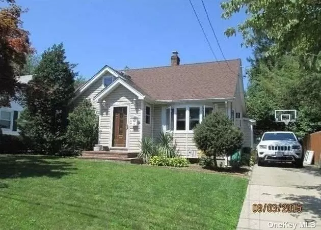 Updated extended cape with 4 Brs and 2 Bath. Living Rm, Oversized eat in kitchen with Bosch Appliances, large Dining Room/Family Rm, 2 Brs and Full Bath on 1st floor, 2 Lg BR and Full bth on 2nd fl. Laundry & Utility Rm in Basement,  Hardwood Floors throughout, Detached Garage, Convenient location to LIRR and Shopping