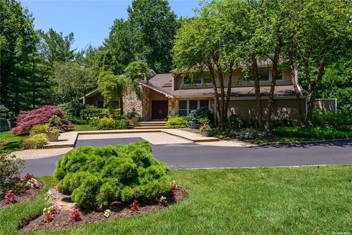 This exquisite one-acre post modern colonial is nestled in the highly sought-after area of Woodbury Rolling Hills 1. Boasting total privacy, the property offers a country club-like yard with a heated inground gunite pool accompanied by a cabana that has changing rms. Upon entering you&rsquo;ll be greeted by an open layout with high ceilings, creating a sense of grandeur and spaciousness. The European kitchen is a chef&rsquo;s dream, equipped w/top-of-the line appliances including a commercial-grade Sub-Zero refrigerator/freezer. The home features a 16-zone sprinkler system ensuring a lush and well maintained landscape. With 5 bedrooms and 4.5 baths there is ample space for a growing family or accommodating guests. The finished basement provides a recreation area complimented by 3 large cedar closets and a full bath. For added convenience the property is equipped w/state-of-the-art while house generator, ensuring uninterrupted power supply. The home&rsquo;s interior is adorned with vaulted ceilings and skylights allowing natural light to fill the space. A cozy family room with fireplace adds warmth and charm. The entire 1st floor is adorned with hardwood flooring, adding a touch of elegance. Safety and security are paramount with a security system complete w/5 cameras. The open & spacious layout is enhanced by a 4 zone gas heating system & central air conditioning ensuring comfort throughout the year. Outside the property features mature specimen plantings creating a serene & picturesque environment. Conveniently located, the home is in close proximity to shopping centers, parks, the LIRR and houses of worship. Additionally it falls within the boundaries of the prestigious Walt Whitman Elementary & Syosset High School. The primary suite is truly stunning boasting a brand new primary bath that exudes luxury & sophistication. For added convenience there is a bedroom and full bath located on main level ideal for guests or mutigenerational living. This one-acre post modern colonial offers a harmonious blend of luxury, privacy and convenience providing the perfect retreat for modern living.