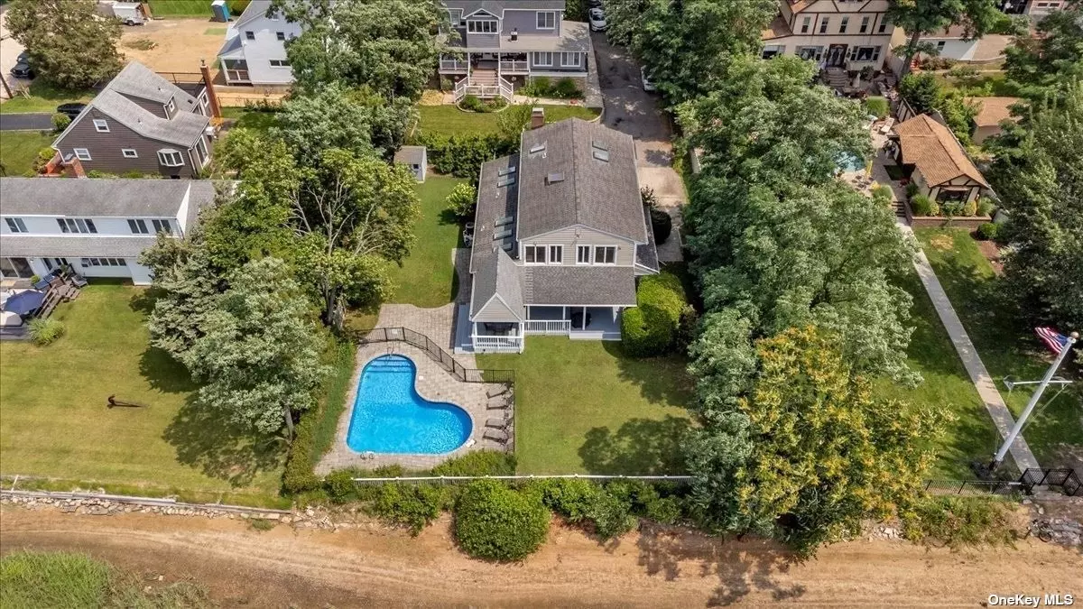 Welcome to 8 Lauren Lane in Bayville, NY! This stunning waterfront colonial offers a serene and peaceful retreat on a quiet dead-end street. Prepare to be captivated by the breathtaking views of Mill Neck with 92 feet of waterfront and enjoy direct beach access. As you approach the property, you&rsquo;ll notice the oversized landscaped yard, creating a picturesque setting for this 2700 square feet home. The exterior features a heated in-ground pool, adding to the luxurious amenities of this home. Additionally, you&rsquo;ll find a large veranda and a covered deck equipped with fans and lighting, providing the perfect spot to relax and watch the boats sail by. The deck offers panoramic views of the water, wildlife, and nature, making it an ideal place to witness stunning sunsets. Inside, the home boasts an abundance of windows strategically placed to showcase the magnificent water views from almost every room. The main level welcomes you with a spacious entry hall leading to a formal living room and dining room, both offering uninterrupted water vistas. The eat-in kitchen features granite countertops, a slider to the deck, and, of course, more scenic water views. Adjacent to the kitchen, you&rsquo;ll find a cozy family room complete with a fireplace, creating a warm and inviting atmosphere. Convenience is key with a laundry room located on the first floor, ensuring ease of use. Additionally, a generous storage room, utility room, and access to a modified 2-car garage for extra storage space are available. The second floor hosts the primary bedroom, which boasts an en-suite full bathroom featuring a separate bath and shower, and ample storage. Three additional bedrooms, including two with water views, offer comfort and versatility, each featuring hardwood floors, ceiling fans, and high hats. The hallway bathroom is equipped with double sinks, ensuring convenience for the whole family. Two linen closets provide additional storage space. This home is equipped with gas heating and features nine skylights, allowing natural light to flood the interior spaces. Situated just 25 miles from New York City, you&rsquo;ll have easy access to all the amenities the city has to offer while enjoying the tranquility of Bayville. Nearby, you&rsquo;ll find a variety of restaurants, shopping options, an exercise path, and opportunities for boating, sailing, and swimming, as well as mooring and beach rights. 8 Lauren Lane is a true waterfront oasis, combining the beauty of nature, stunning water views, a heated in-ground pool, and a comfortable and spacious home. Don&rsquo;t miss the chance to make this exceptional home your own.