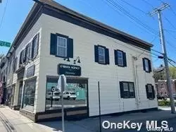 High visibility location for office or retail use with 2 apartments. A 2 Bedroom $1900pm, A 1 Bedroom $1600pm and Office $2700pm. Fully occupied. Sun drenched Corner property on busy Main St location with full wall display windows. Walking distance to ferry, theatre, railroad, shops, restaurants. Bus stop across the street! Space has been totally renovated. Super clean. 5 parking spaces in rear of building! Tenants pay utilities, oil (heat), electric (PSEG) garbage pu. Landlord pays taxes, water. Taxes: $10, 032.73 plus Village Taxes $2, 623.22  Location! Location!