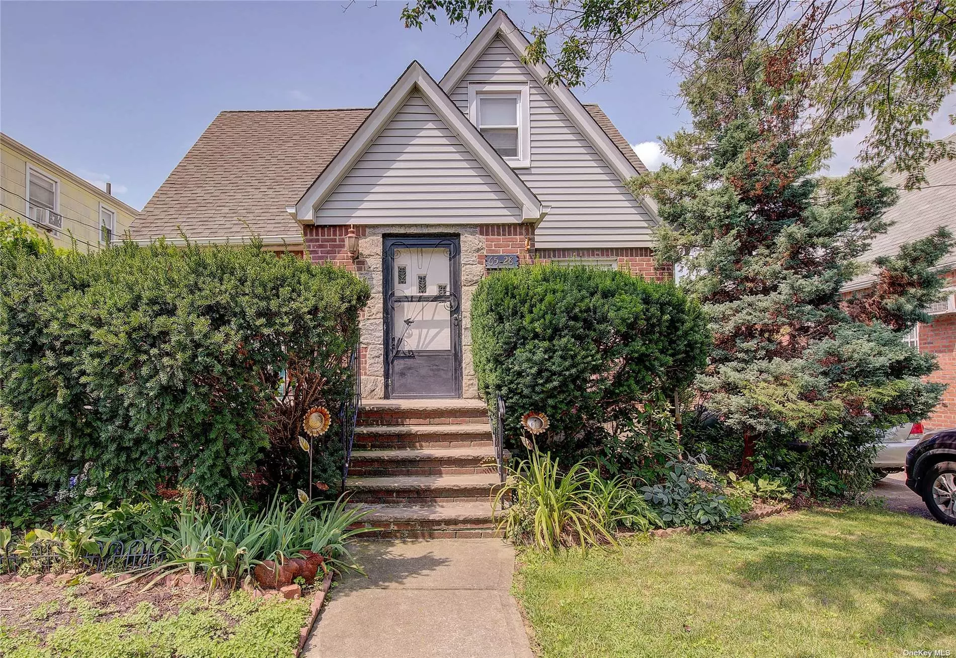 Cape House in Fresh Meadows boasts a charming front porch and a brick/vinyl exterior. The property features a private driveway leading to a detached garage for convenient parking. The interior showcases 3 bedrooms and 2 bathrooms, providing ample space for individuals seeking room to grow. With 6 ceiling fans (3 on the first floor and 3 on the second floor), comfort is assured throughout the home. The first floor features 2 bedrooms, a full bath, an eat-in kitchen, a formal dining room, a spacious living room, and lovely hardwood floors. Moving to the second floor, you&rsquo;ll find another full bath and a bedroom, along with an additional living room that can easily be converted into another bedroom. Furthermore, there is extra usable space that can be transformed into yet another room, offering versatile options for personalization. The partially finished basement features a separate door leading to the backyard, ensuring a safe egress. Currently divided into rooms, the basement layout can be easily modified for a more open concept if desired.