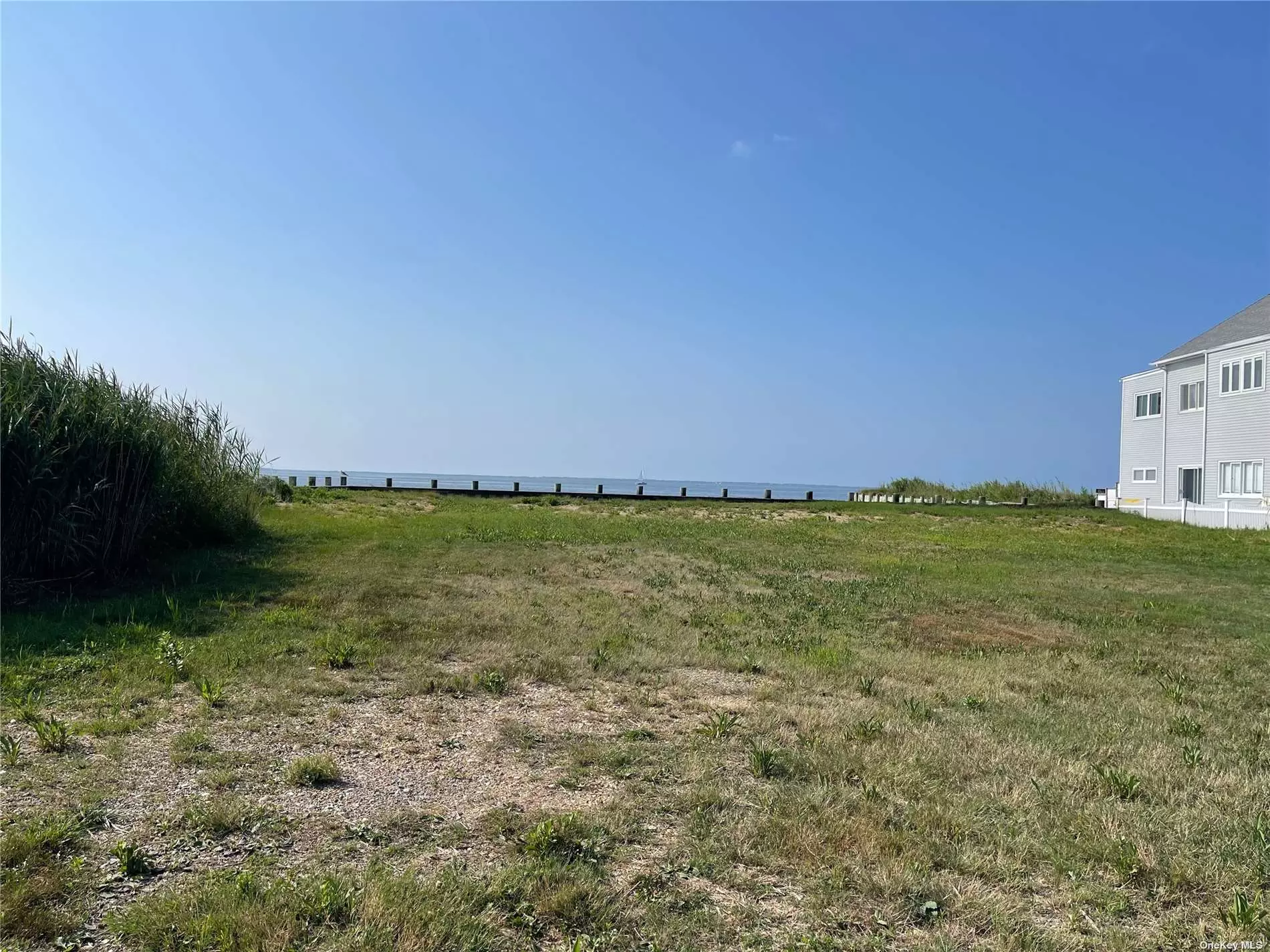 Buildable .38 acre of cleared waterfront property with 63.71 new bulkhead in 2018. Tax classification 282: Two (2) year round dwelling units on one parcel. Also zoned for mixed use. Cesspools, water, electric and gas lines in place (2). Next door to Sayville beach. Down the road from the Fire Island Ferry dock and Lands End Restaurant. Don&rsquo;t miss the chance to secure this premier waterfront lot on the Great South Bay.