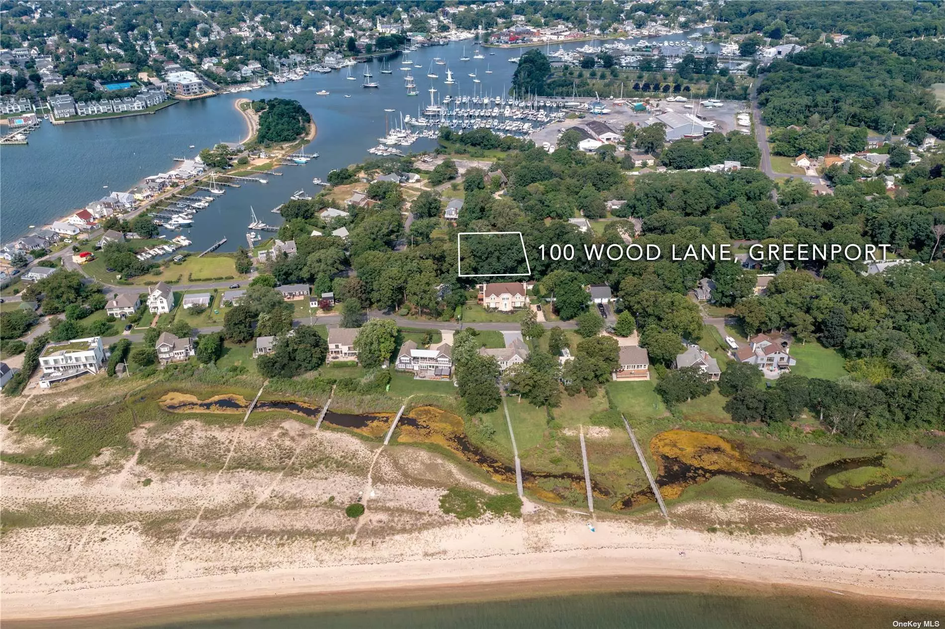 Located less than a mere 500 feet from a sandy bay beach, this quarter acre flat parcel of land gives you immediate access to all of the amenities Greenport Village and the North Fork have to offer. Whether your mode of transportation be a vehicle, motor boat, sailboat, paddle board, or bicycle, you can use any method of transport to get to renowned restaurants, wineries, boutique stores, farm stands and Mitchel Park and Marina in the heart of Greenport Village. .
