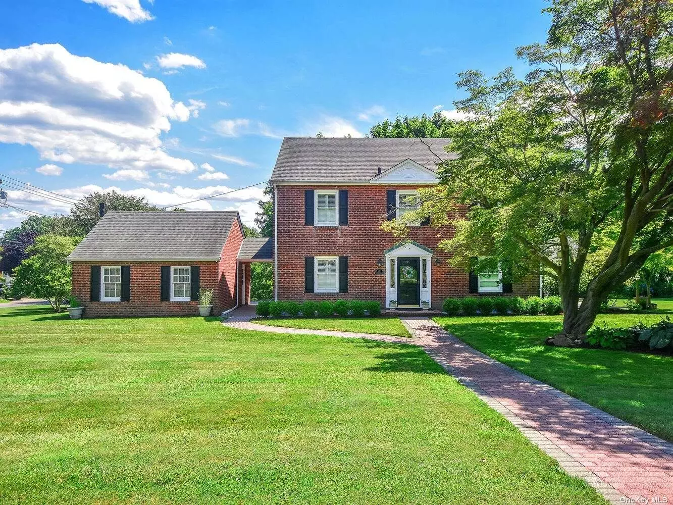 Stately and sprawling, this brick Center-Hall Colonial is full of old world charm with detailed moldings, a grand staircase, and cross cut wood floors. The veranda offers outdoor living with access to the large, lush landscaped half-acre with room for a pool. The home boasts modern amenities such as central air conditioning, in-ground sprinklers, extensive draining systems, a two car garage and more. This 3 bedroom, 2.5 bathroom home on a coveted street is close to all - beaches, golf course, train and more.