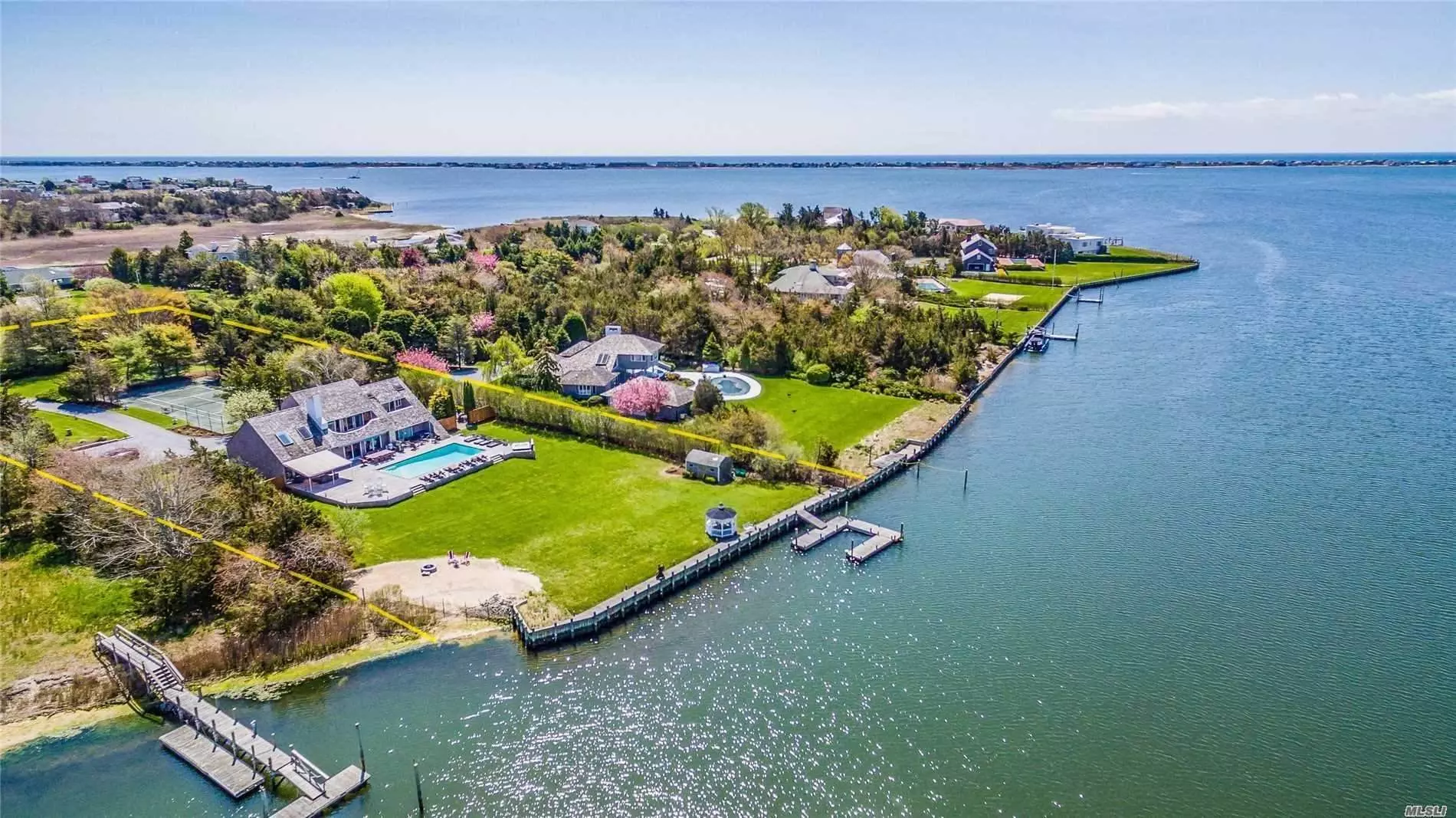 WIDE OPEN WATERFRONT, 1.64 Acres in Prestigious Atlantic Farms in Westhampton with homes valued up to $10, 000, 000. 140 Feet of Bulkhead, Deep Water, Huge Floating Dock, Sandy Beach, Heated Gunite Pool, Hardwood Decking, Expansive Lawn, Har-Tru Tennis Court, Totally Private Setting. Beautiful Sunsets, Large Chefs Kitchen with Fireplace 4 Bedroom, 4 Bath, Living room with high ceiling and Fireplace. Garage. Finished Basement with large Bedroom and a Full Bath possible, Owner has applied for Permits, Exercise room and plenty of storage.