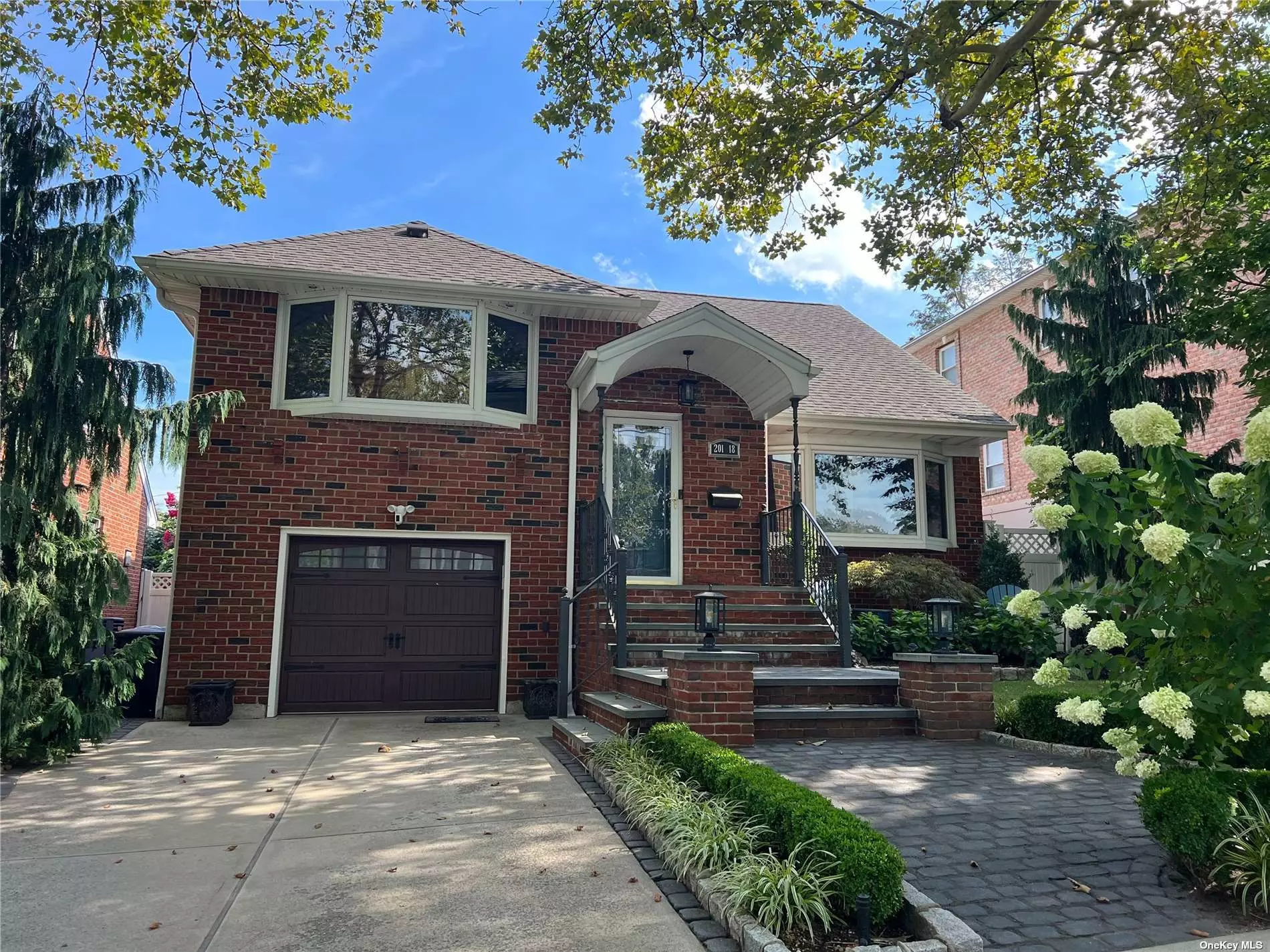 A Must See! Fully renovated expanded 5 level split ranch on a quiet tree-lined, park like block in Bayside. This home features 3 bedrooms, an office/den, full finished basement used as a family room, and 2 full baths with one car garage. The rear of the house received an extension in 2012 to create a luxurious kitchen with cathedral 14&rsquo; ceiling. From there you have sliding doors that leads to a Tuscan style Patio. The patio area includes a built-in stone BBQ with storage and peninsula island with granite countertop. The entire backyard is surround by lush landscaping. This creates the ideal setting for entertaining. In addition, the house features hardwood floors, central AC, 4 zone hot water heating and French drains. Shops and public transportation nearby.