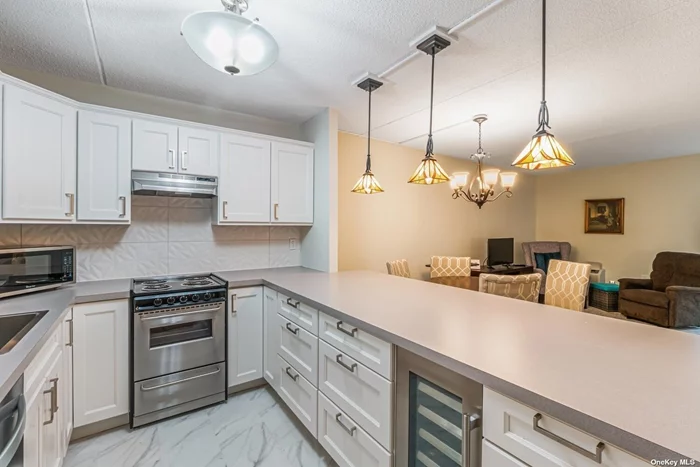 Beautiful one bedroom condo with a master bath. Fully renovated in 2022. Lots of closets, parking space in garage, washer and dryer in unit. Large screen in terrace with new windows. Beautiful kitchen with stainless steel appliances and a wine cooler. Common room in lobby. Adult community age 62+.