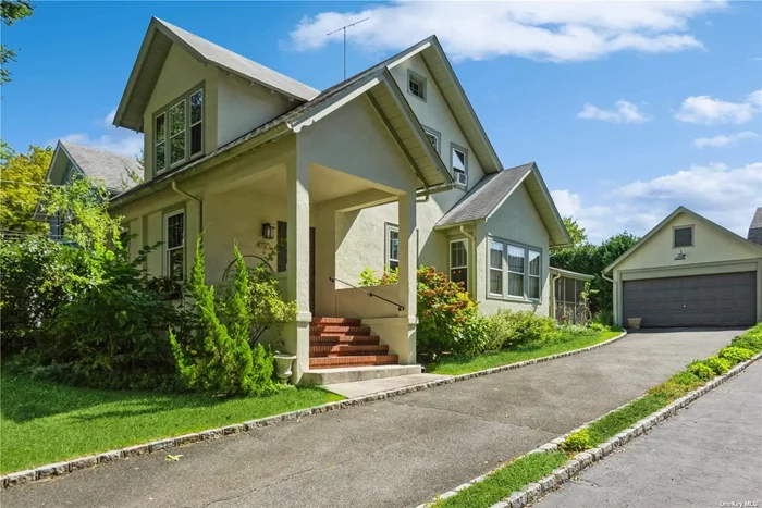 Beautifully restored home in the Park Section of Port Washington. Desirable upper block private location. Enter into a large, light filled living room/family room with high ceilings, wood burning fireplace and meticulously restored oversized windows with beautiful wood panes. A large Eat in Kitchen and dining area offer great space for cooking and entertaining. An inviting screened-in side porch can be used for al-fresco dining or a place to relax. The backroom with vaulted ceilings, reclaimed wood beams and a door leading to a private back deck, can be used as a bedroom or a family room. with a full bath attached. A powder room completes the first floor. An inviting wide staircase leads to the second floor. 3 additional bedrooms and a full bath. Attic space. Large walk-in hall closet. The beautifully restored, oversized period windows can be found throughout the house. Full basement with laundry.Two car detached garage with a staircase leading to ample storage space. Located in the waterfront community of Port Washington. Close to town, train, restaurants and shopping. Direct commute to NYC Penn Station or Grand Central Station. Welcome Home.