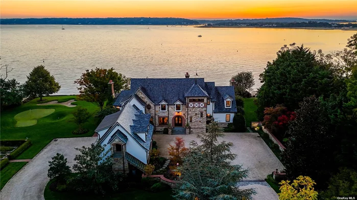 Overlooking picturesque Oyster Bay Harbor, this stately waterfront Manor home is located on 1.71 acres and boasts 245 feet of water frontage. Featuring 6 large bedrooms with walk-in closets and 7.5 baths with high-end fixtures and fittings, this magnificent property has an idyllic master retreat on the main floor with incredible views across the Harbor, 2 spacious walk-in closets with center islands, and a luxurious marble master bathroom with a soaking tub and an incredible shower for two.  The foyer, with its grand mahogany entry doors and fielded wainscot paneling, leads to an open-plan bright and airy great room with a dramatic two-story ceiling, floor-to-ceiling stone fireplace, clerestory windows, and 3 sets of French doors that frame stunning water views. With herringbone floors, built-in cabinetry that offers ample storage, and glass doors for displaying china, the elegant dining room is perfect for gracious entertaining. The chef&rsquo;s kitchen has been designed with custom cabinetry, professional-grade appliances, 2 walk-in pantries, marble counters, an expansive marble center island with inlaid walnut butcher-block ends, and an octagonal breakfast area that overlooks the shore. A lovely conservatory/sunroom with terracotta flooring and a fireplace is located off the kitchen and offers an ideal spot for relaxing.  The lower walk-out level features a paneled family room with a fireplace and coffered ceiling, a billiard room, temperature-controlled wine cellar, exercise room, custom onyx wet-bar, and an amazing home theater with a coffered ceiling, comfortable leather seating, and sound-proofed walls. The exterior has a generous bluestone patio, outdoor kitchen, and an incredible infinity pool in a beachfront setting with professional landscaping, manicured formal gardens, yoga platform, and a putting green. Additionally, there is a charming guest suite with a bedroom, bathroom, kitchenette, living and dining area. Complete with 6-zone central air conditioning and 15-zone heating systems, in-ground sprinklers, a 2-car garage, this exceptional Smart Home is the epitome of timeless design and showcases exquisite architectural details with extraordinary craftsmanship throughout.
