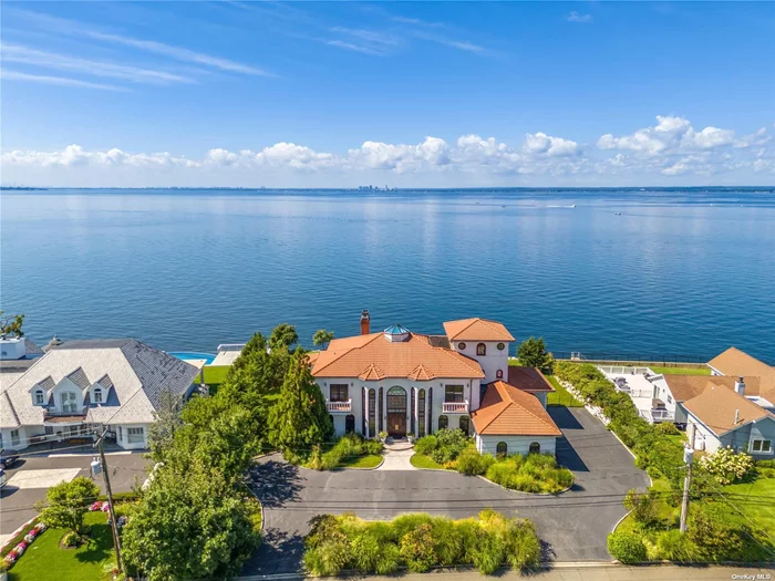Embrace the allure of island living in this elegant custom built waterfront gem. This masterpiece of architecture encapsulates the privacy & serenity of waterfront living on the iconic Morgan Island. As you walk through the grand foyer with a 20ft ceiling a sense of wonder envelopes you as your greeted by the breathtaking water views and spectacular sunsets. Welcome your guest with a massive skylight that will direct natural light to a glass floor inlay providing light to your heated indoor gunite pool on the lower level. The dehumidification system freshens the whole pool level while the sun shines from above. Impress with the waterfront balconies, custom millwork design coffered ceilings in the dining room and the den, and stunning floor to ceiling windows with 180 panoramic view of the Manhattan skyline. Every corner of this four level home has an air of refined living, including a seamless transition between floors on your total home elevator. Your island retreat offers manicured landscaping with a luxurious heated gunite outdoor pool & spa. A 10 year old seawall & retaining wall with a life span of 100 years. Security is forefront with rear window & door shutters, alarm system, gas generator & steel construction. This exquisitely designed home spans over 6000ft & features a sitting area, grand living room with wood fireplace leading to a sprawling waterfront balcony, a first floor primary bedroom suite with sitting area, spacious balcony overlooking the water, Jacuzzi & steam shower, Formal Dining Rm, Family Rm, Large gourmet Chef&rsquo;s Kitchen w/Dining Area, Powder Rm, & Guest Bedroom w/en-suite. All marble floors on the entire first floor and lower level provides you with the warmth of radiant heated floors. Second Floor features three bedrooms with 2 full bathrooms, four balconies & office w/sitting area. Third Floor features a finished attic room. Basement includes a heated gunite indoor swimming pool, full bathroom w/steam shower, family room, optional gym/flex room, spacious electrical storage room. You&rsquo;re invited to view this island retreat of luxury, privacy and tranquility where your story can unfold in your new home.
