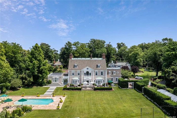 Want to live in a home as rich in history as it is beautiful? This gorgeous compound on the North Shore of Long Island has it all. This one in a million property, which has been under the same ownership for 50 years, boasts 2 separate homes, a coach house, a cabana, a pool and a tennis court, all enclosed by a privacy wall and an electric gate.  Once inside, the property feels like an oasis. The 7, 500 Sq.Ft. Main Residence encompasses 9 bedrooms, 7.5 bathrooms and exudes elegance from every detail of the home. House #2 is a beautiful 6-bedroom Colonial featuring hardwood floors, a stately step-down living room and dining room with mirroring fireplaces and a large Primary Suite with dual walk-in-closets. Both of the homes have full-house generators, attached garages and full/ finished basements.  Situated in an incredible location, the compound is only 26-miles from Manhattan, and enjoys winter water views. This unparalleled home is perfectly positioned between the Long Island Sound and the heart of The Village of Roslyn, with close proximity to the best of the North Shore including luxe shopping, high-end eateries and world-renowned golf courses such as Engineers Country Club and North Shore Golf Club.