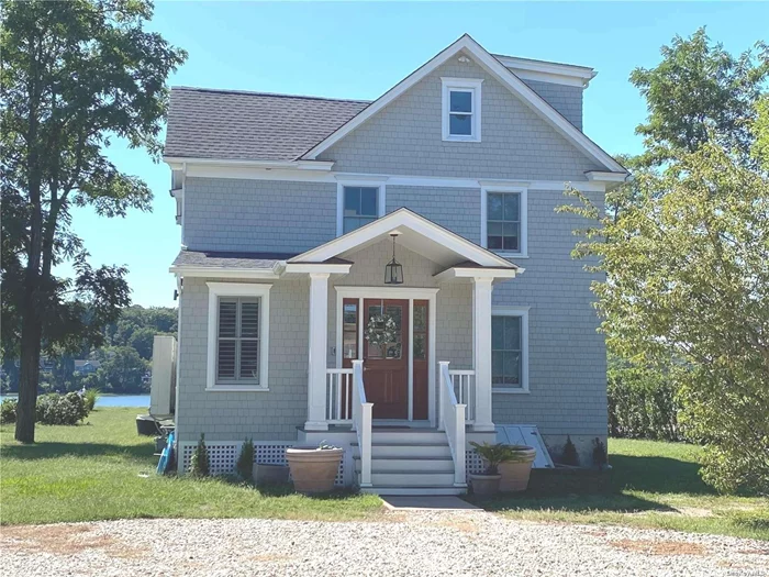 Step into the splendor of this sun-drenched waterfront oasis, exquisitely renovated in 2018. Boasting an open floor plan and private access to the Pine Island Park Beach Association, this bay front gem is a showcase of high-end features, including marble bathrooms, quartz countertops, and stainless steel appliances, with a Wolf six-burner gas stove as the centerpiece. The expansive deck off the great room invites outdoor entertaining, while a queen bedroom and bath on the main floor provide convenience. Enjoy a breathtaking bay view from every angle. The primary bedroom and bath open onto an upper deck. Complete with central air, this home is situated on a picturesque, level acre of land. Welcome home!