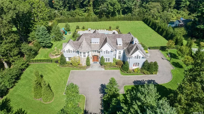 Built in 2017 by renowned North Shore builders, The Worrel Group, this spectacular 7230 sq. ft. residence sits on 2.1 manicured acres. This magnificent home features 6 bedrooms, 6 bathrooms, and a powder room. Features a soaring 2-story entry foyer with floor-to-ceiling fielded-panel wainscot, walk-in coat closet, powder room, and gorgeous herringbone floors. The library is designed with a coffered ceiling, elegant formal dining room showcases mirrored inlaid panels, and the formal living room has French doors with a custom ceiling and a fireplace. Family room with fireplace and coffered ceiling open to an incredible kitchen with a large center island, high-end fixtures and fittings, professional-grade appliances, breakfast area, and a walk-in butler&rsquo;s pantry with additional storage, wet bar, and wine refrigeration. Master suite boasts a fireplace, private sitting room, dressing room with a large walk-in closet and center island, and an opulent master bathroom with a spa-like shower, air tub, and barrel-vaulted ceiling. Outside features a generous bluestone patio with a firepit, outdoor kitchen, and a saltwater gunite pool. Highlights include central vac, alarm system, 60 KW whole-house generator, 10 ft. ceilings in basement, and a 3-car garage. Complete with Locust Valley schools.