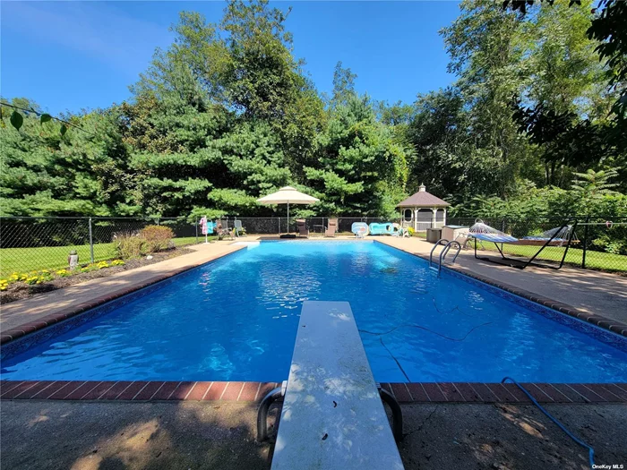 Tucked away at the end of a secluded cul-de-sac in the highly sought-after Westwood Acres neighborhood on the North Fork in Aquebogue, this 3, 274 square foot colonial boasts 4 bedrooms, 3.5 baths, and a full, finished, heated basement. This spacious home is nestled in a private 2.95-acre estate setting, next to forever farmland. Nature enthusiasts will enjoy its proximity to hundreds of additional acres of preserved land with trails and ponds. Off the entry foyer, you&rsquo;re welcomed into a formal living room with French doors that opens into the gathering room featuring woodburning fireplace. Spacious custom kitchen with granite countertops and stainless steel appliances and formal dining room are ideal for hosting dinners. Dinette, powder room, and the convenience of a main floor laundry, and 3 car garage complete the first floor. Off the gathering room is a patio, and inground heated pool. The owner&rsquo;s suite offers a spacious bath and closet space. Additionally, there are 3 guest bedrooms and full guest bath. The location is within easy reach of the South Fork and LIE, and all the North Fork has to offer: dining, wineries, farmstands, marinas, shopping, beaches, boat ramps, state and county parks, golf courses, medical offices, the aquarium, and live theatre.