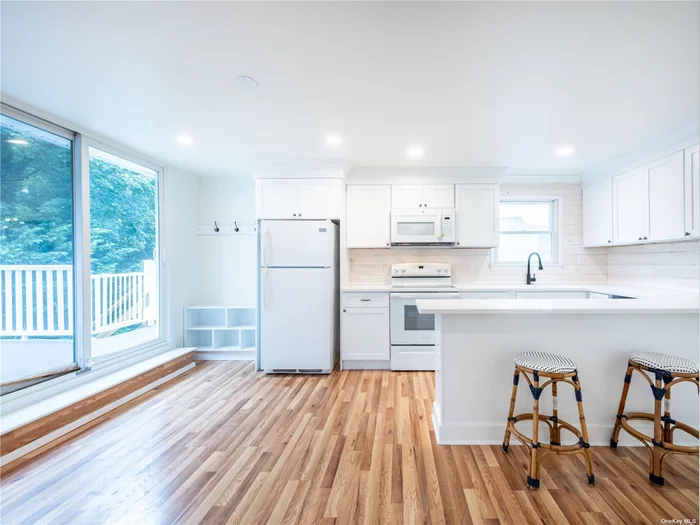 Newly renovated 2nd floor 1 bedroom apartment with brand new white kitchen with quartz counters and new appliances. Washer/Dryer in unit as well as large walk-in-closet. Private deck off of kitchen.