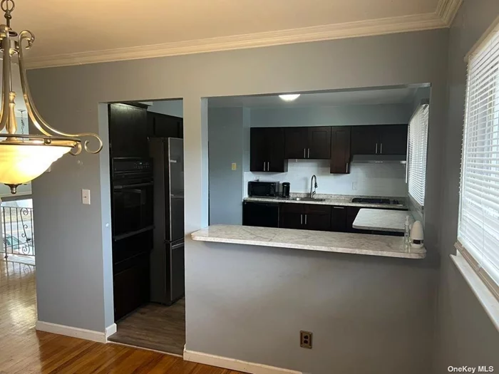 This 3 bedroom, 1full bath updated, features large living room with dining area with oak floors throughout, custom kitchen with gas cooking and a new flooring, heat electric and water included.