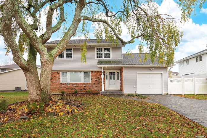 Welcome to 8 Navy Dr, Smithtown! This charming colonial home offers the perfect blend of comfort and convenience. With three bedrooms and 1.5 baths, it&rsquo;s the ideal size for a family. Situated on a generous .25-acre lot, there&rsquo;s ample space for outdoor activities and gardening. The partially finished basement provides extra room for storage or recreation. As you step inside, you&rsquo;ll notice the inviting open layout. The living room seamlessly connects to the dining area and kitchen, creating a perfect space for entertaining guests or family gatherings. The den opens to sliding doors that lead to a lovely backyard, providing a tranquil spot for relaxation. This home boasts beautiful hardwood floors that add warmth and character. The roof and windows are only six years old, ensuring durability and energy efficiency. Additionally, the brand new vinyl siding not only enhances the property&rsquo;s curb appeal but also offers low maintenance. The exterior features a paver driveway and walkway, making your entry stylish and easy. The PVC fenced yard ensures privacy and safety for children and pets. For your comfort, the home is equipped with both gas heating and cooking, along with central air conditioning. This residence is part of the esteemed Smithtown school district, making it a great choice for families. Don&rsquo;t miss the opportunity to make 8 Navy Dr your new home sweet home!