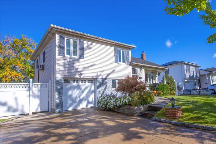 Beautiful updated split level located in Groves Syosset. 4 Bedrooms, 2 full bath, An Extra Large Dining Room And Eat-In Kitchen, 1 car garage, hardwood floors, stainless steel appliances, CAC, pvc fence, Wonderful Access To The Neighborhood Park. Close To All. South Grove Elementary.