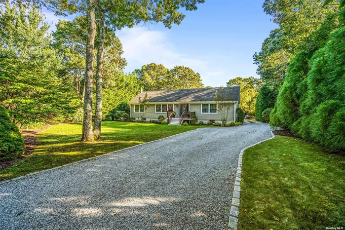 Tremendous opportunity to own a very private getaway in the Hamptons. Property lined with mature trees and park-like landscaping. This large ranch displays pride of ownership at every turn and boasts 3 total bedrooms. Large master bath was recently renovated and features marble flooring, full glass marble shower and outside backyard access. Backyard is a private oasis with towering green giants surrounding a beautiful mahogany deck. Maple flooring covers this sprawling 1600sf+ ranch that provides a large & open eat-in kitchen and central AC. Home has a full basement with tall ceilings and plenty of potential. This property includes a massive bonus dwelling built in 2010 that includes garage space for up to 4 cars, radiant floor heating and 1200sqft of unfinished possible living space on the 2nd floor. Structure is currently being used as a workshop but has endless possibilities for future owners. Tiana Beach community club rights for an annual fee. This home is in the heart of the Hamptons and provides easy access to most ocean beaches and farms that make the south fork so desirable. Call to make this your new Hamptons home!