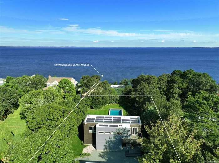 Nestled along the sun-kissed shores of the Hamptons, this extraordinary Modern Beach House is a serene retreat with a pristine private Peconic Bay beach. This striking residence epitomizes the marriage of European sophistication with contemporary allure. Set on a shy 3/4 acre lot, perched high above with commanding views of the expansive waters of the Peconic Bay, this beachside home flawlessly combines sustainable modernity with a European flair. The interior of this residence is a testament to luxury and eco-conscious design. High ceilings, stunning bamboo hardwood flooring, and floor-to-ceiling glass create a bright and airy atmosphere, letting in an abundance of natural light. With three bedrooms and two baths, this is the perfect Hamptons summer getaway. A fully equipped chef&rsquo;s kitchen, complete with stainless steel appliances, ensures that meal preparation is a delight, especially with the endless Bay views as your backdrop. A series of expansive, multi-level mahogany decks encircle the property, creating the ideal setting for beachside living. Whether you&rsquo;re hosting elegant gatherings under the stars or seeking a peaceful retreat to enjoy the saltwater Bay breeze, these outdoor areas are a seamless extension of your coastal sanctuary. An oversized saltwater gunite pool, wrapped in mahogany, is perfect for entertaining throughout the summer. Just steps from the pool lies your private Bay beach, an exclusive sanctuary where you can enjoy the soft sands, the gentle lapping of the waves, and the pure bliss of beachfront living. All of this is conveniently located within minutes of local marinas and renowned shopping and dining options. This European-inspired modern beach house is more than a home-it&rsquo;s a haven of elegance and serenity in the heart of the Hamptons.