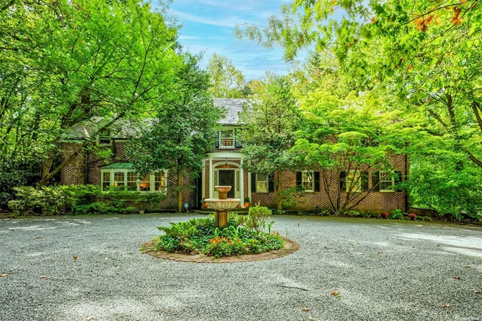 Nestled in the timeless charm of Mill Neck, a long winding driveway leads to this stately brick manor home on 3 private acres. The grand entry foyer sets the stage for the generous living spaces with oak floors throughout. Living room w/fireplace, built in bookshelves, den, glass enclosed porch, formal dining room, eat in kitchen, and a main floor ensuite bedroom. A graceful curved stairway leads to the second floor. Master suite w/fireplace, dressing area, full bathroom and balcony. Three additional ensuite bedrooms. The third floor offers bonus space and full bathroom. Private yard w/In ground gunite heated pool and slate patio. 3 car attached garage, full basement, CAC, in ground sprinkler system, and security system. This 4000 sqft manor home, with its classic architecture and grounds is reminiscent of the bygone Gold Coast era. Low Taxes!