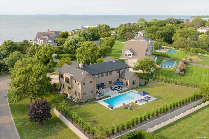 2024 Rates: July 22-LD $53K; July 27-LD $48K; A1-LD $42K: Chic & Sophisticated. This Modern Hamptons style home offers everything you could ask for from a Summer retreat to the East End. Featuring over 3500sqft of living space, the impressive Great Room is the centerpiece of the house and flows seamlessly to the rear yard which features a 20x40 heated gunite pool with sun deck, large architectural stone patio w/ fire-pit and large gas fired grill. In addition, you will enjoy lazy summer walks to the Rock Cove Estate community private Sound side beach and peak-a-boo water-views from the second floor. All bedrooms are generously proportioned but the Primary En-Suite is truly spectacular with high vaulted ceilings, private waterside balcony, walk in closet and En-suite full bathroom. Bonus feature, the second floor offers a game/media-room w/ full-size pool table, shuffle board table and waterside balcony. Don&rsquo;t let this amazing offering slip away!