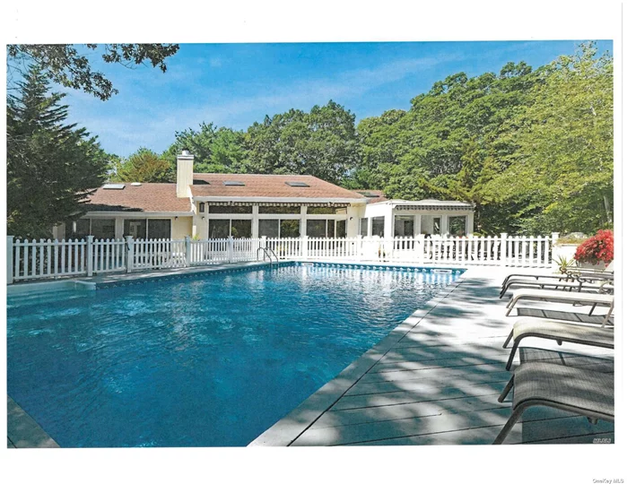 This timeless Quogue contemporary with pool and tennis has been meticulously maintained. Located on a quiet private lot on a noted Quogue street, this could be your next vacation or year-round home. In classic style, this contemporary features a huge living/dining great room that connects into a large kitchen via a pass through wet bar with stools. Additionally, this unique layout offers a large sunny family room that looks out over the shimmering pool and wood decks. Natural light abounds through numerous skylights and a wall of sliders looking out to the resort-like backyard. Radiating from the great room, you will fi nd 4 comfortable bedrooms and 3 full bathrooms, featuring a substantial primary suite overlooking the pool and a comfortable guest en suite. Natural oak floors are throughout. Luxuriate in your own private resort with a heated and illuminated 20ft by 40ft pool, hot tub and regulation Har-Tru tennis court. Expansive decking is ideal for al fresco entertaining under multiple electric awnings and privacy is ensured by surrounding mature and delightful foliage. A partially finished basement with extra half bath provides a secondary fun space option. Exclusive private Quogue Village beach rights and low Quogue village taxes.