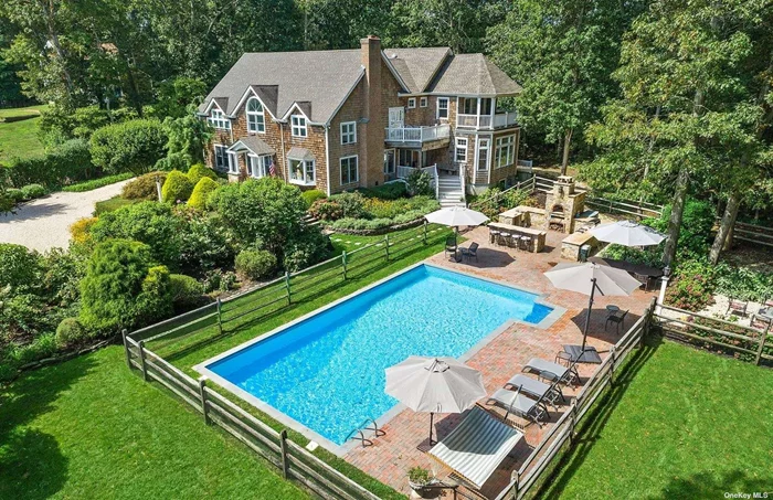 Welcome to 652 Noyac Path, Water Mill! Enter this gorgeous, gated property and feel the tranquility of 1.19+/- lush acres located across from a scenic farm vista. With over 4, 600+/- sf of living space above grade and an additional 2, 810+/- sf in the lower level, 6 bedrooms and 7 bathrooms, this spacious home has it all. Upon entry into the double-height foyer, you will notice the home is flooded with natural light and an open floor plan. With a perfect set-up for entertainment, dinners can be crafted in the stunning professional chef&rsquo;s kitchen featuring all Wolf and Sub-Zero appliances with a large center island with a second sink, quartz countertops and a dedicated coffee station. The great room, with double ceilings, is conveniently located with a fireplace, plenty of windows bursting natural light, a new bar with sink, dishwasher, refrigerator, ice maker and a wine cooler. The well-thought-out layout allows for open entertaining, as well as intimate gatherings. The renovation and extension were completed in 2017 by renowned interior designer, Elsa Soyars. Featuring 2 true primary suites, the first floor primary suite has a bathroom with an air tub, as well as an additional guest bedroom, office and a den. The second floor offers an additional primary bedroom with multiple decks offering beautiful farm views, a junior bedroom and 2 additional guest bedrooms The full, finished lower level features an entertainment/TV area, a large full bathroom, cedar wine storage, playroom, gym and a storage room. The oversized 2.5 car garage, with service doors, can accommodate 3 cars and also features radiant heated floors. An electrical generator for the home provides continuous protection. Step outside to the magnificent grounds and find a large heated swimming pool with brick patio amidst an English style garden providing a secluded setting. The outdoor kitchen offers a brick pizza oven/stove from Italy, a bar with sink with hot and cold running water, 2 refrigerators, a smoker grill, a 2-burner stove set with granite countertops and a seating area with firepit completes the amenities of this wonderful multiple outdoor entertaining area. Surrounded by horse pastures and farm fields, enjoy this enchanting home, privacy and peaceful environment! Ideal Hamptons living at its finest!
