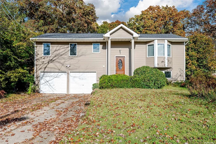 Wide line Hi Ranch in a beautiful neighborhood. This home has a large rear yard, 2 car attached garage, bamboo wood floors. Baths, Eat in Kitchen, roof and boiler under 6 years old. Large wood deck off kitchen. Ready to move in!!