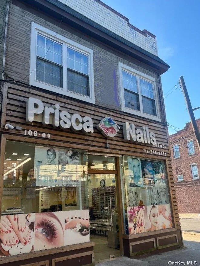 Mixed use building for sale with 2 apartments (each with 2 BDS/1BTH) on the second floor and 2 operating businesses on the ground floor with an attached garage1 block from the A train and close to Q112 Bus.