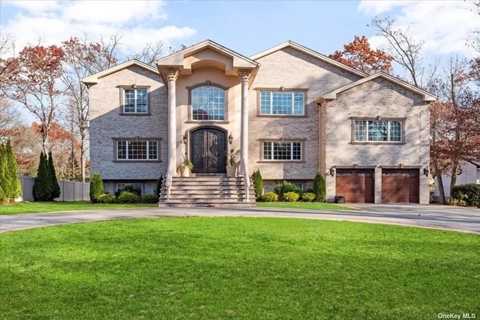 Welcome to this stunning custom brick Colonial nestled in The Pines of Smithtown. This exquisite 4-bedroom, 2.5 bathroom home offers a luxurious living experience with a wealth of interior and exterior features. Upon entering, you are greeted by a vaulted entry foyer and a floating staircase, setting the tone for the elegance that awaits. Porcelain tile floors with porcelain base molding flow throughout the first floor, custom tiered crown molding throughout , and an abundance of windows that flood the space with natural light. The formal living room and dining room provide the perfect setting for entertaining, while the separate level family room and recreation room with a woodburning fireplace offer a cozy retreat. The Cherrywood kitchen is a chef&rsquo;s dream, featuring granite counters, stainless steel appliances, a center island with a wine fridge, and an additional dining area. The primary en suite is a true sanctuary, featuring tray ceilings, a bathroom with a granite Jacuzzi tub, walk-in shower, water closet with bidet and a huge walk-in closet. Three additional bedrooms and a guest bathroom provide ample space for family and guests. The home also boasts hardwood floors, overhead LED lighting, and a full unfinished walk out basement framed out and equipped with plumbing, offering endless possibilities for customization. Step outside to discover the impressive exterior features, including a circle driveway, 2-car garage, rear paver patio, and trex deck. The radiant heat throughout the house and 3-zone central air ensure comfort year-round. Conveniently located and built just 7 years ago, this home offers a perfect blend of modern luxury and timeless elegance. Don&rsquo;t miss the opportunity to make this exceptional property your own. Experience the beauty and sophistication of this magnificent home in person!