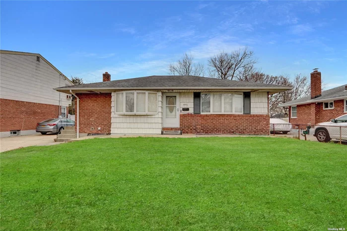 Completely renovated ranch-style home featuring three bedrooms, two full bathrooms, a finished basement with a walk-out separate entrance, and a detached garage.