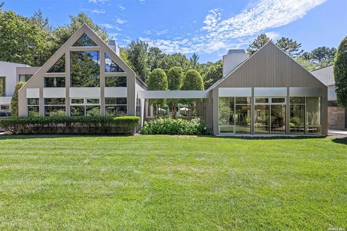Rental Reg. # 22-1, 364. This world class retreat by renowned architect Bruce Nagel is an entertainers dream home. Located equidistant between Sag Harbor and East Hampton Village shops, restaurants, and world-class beaches, this striking residence expertly blends simple, sleek, modern aesthetics with classic, country-barn architectural style. The result is a magnificent compound of 3 cohesive contemporary barns that are seamlessly joined with flawless open interior spaces and stunning outdoor elements. This immaculate home epitomizes casual sophistication, equally comfortable for residents and their guests alike with four luxurious living areas for chic entertaining or for tranquil reflection. Sited on 2 very private acres, the expansive grounds with specimen gardens, fountains, and private patios equally impresses. The home features 6 bedrooms, 6 full and 1 half baths across 7, 000+ sq ft of light-filled living space. Walls of glass surround the living/dining/kitchen+great room with fireplace and showcase outdoor dining and lounging patios that surround a heated, gunite, salt-water swimming pool. The primary suite is set in its own private structure with 25&rsquo; ceilings, a fireplace with lounge area, en suite bath with soaking tub, and an exclusive outdoor courtyard with spa. Five comfortable en suite guest bedrooms are located in an additional structure which also includes a library/sitting room with high ceilings, a wood-burning fireplace, and views of the grounds. The professional chef&rsquo;s kitchen is fitted with double Wolf ovens, side-by-side Sub-Zero refrigeration units, two dishwashers, stone countertops, and a wet bar with a beverage center. The finished lower level features a large comfy den and office, a gym with Peleton, a sauna with private bath, a cedar wood & glass wine cellar and a double stacked laundry room. Additional amenities include a gated entrance providing privacy and security, fabulous landscape lighting for your evening enjoyment, a formal entrance with reflecting pools, a 3-car garage, outdoor shower and a house manager provided at the owners expense. 7 Rolling Wood is your ticket to an unforgettable summer in the Hamptons.