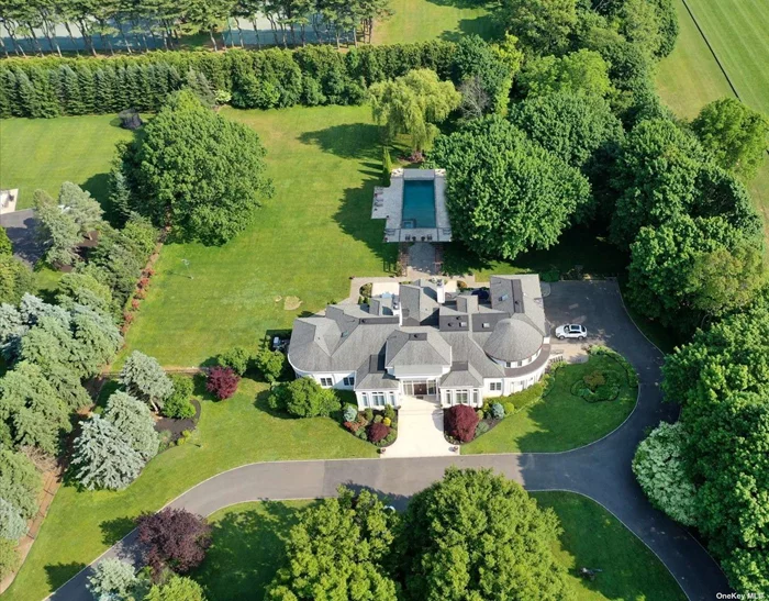 Major Tax Reduction! Welcome to 4 Polo Drive, a spectacular estate located in the sought-after Old Westbury community. This 12, 048 square foot home includes 4, 000 sq ft legal basement. This home features 14 rooms and 10.5 baths, 7 of which are en-suite. This home offers ample space for those looking to live, work, and entertain in luxury. As you enter the home, you&rsquo;ll be greeted by a grand foyer and magnificent custom staircase that lead you to both the formal living & dining rooms, as well as opening to the exquisite great room that overlooks the gorgeous property. The primary suite is located on the main floor and features a beautifully renovated en-suite bathroom that boasts a sauna, steam shower and elegant standalone tub. Additionally, the home features an elevator that services all floors, making it easy for everyone to move around. One of the standout features of this property is the fully legal basement, which spans over 4, 000 square feet. This basement is brand new and features two legal en-suite bedrooms, an entertaining area, gym area, cabana baths, and changing rooms. The walkout provides easy access to the backyard and pool area, making it perfect for entertaining guests. The home sits on over 3.26 acres of beautifully landscaped and flat property, providing ample space for outdoor activities. The large 20x50 inground gunite heated pool is perfect for swimming and relaxing on hot summer days. The home also has a 3-car garage and an expansive driveway, providing plenty of parking. Located in the highly sought-after Jericho school district. Its private cul-de-sac location ensures maximum privacy, while still being within easy reach of all the amenities that Old Westbury has to offer. With its luxurious amenities, spacious layout, and prime location, 4 Polo Drive is truly a remarkable property that offers the best of both worlds.