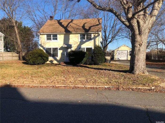 Investor delight or user. 100 x 100 lot size in mid-block location in Bethpage. This home has lots of potential! Possible mother-daughter with proper permit. Each floor has two bedrooms, living room, full bath, kitchen, and two separate meters. Detached garage, huge backyard. Side entrance to basement. Long driveway that can fit 7 cars. Close to train and shopping. Sold as is. Must see!