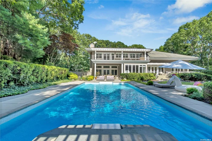 Trees, foliage, and a long driveway await you as you open the gates to 170 Northside Drive. Located Conveniently 5 mins to Sag Harbor Town Beach! As the door opens, you are greeted by a grand foyer with vaulted ceilings and an elegant chandelier. Off the foyer is a living room with a wood-burning fireplace, a gracious dining room with floor-to-ceiling French doors leading to a stone patio, an office and a guest powder room. Not to be missed is an open kitchen and dining area which enjoys views of the rear garden and pool. Off the kitchen sits a beautiful great room with another wood-burning fireplace, wet bar, mini-fridge, and wood shelving for your entertaining convenience. As you travel to the upper level landing, you experience a sense of balance, openness, and light-architecture at its best-with three bedrooms, two bathrooms (en-suite in master), and a large laundry room with a window of its own. Each level of this home opens to the outside area that looks at beautiful gardens. The middle and lower levels are fitted with French doors and the upper level with an extensive terrace. On the lower level, a beautiful Japanese garden and pond are adjacent to an apartment of its own with a bedroom, office, a full bathroom, a recreational room and a pool table too! A two car attached garage leads out to more arbor beauty. If this is not enough, come and enjoy the 20x40 pool-lounge and relax in a magnificent pool house, equipped with kitchen, fireplace, and living area.