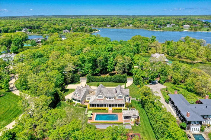 Situated on 2.8 waterfront acres on prestigious Bay Road in the Village of Quogue, this grand shingled residence offers the ultimate in Hampton&rsquo;s living! Enter through private gates to the 6, 400 sq. ft. custom-built home featuring 6 bedrooms and 7.5 fully tiled baths. A stunning double-height foyer opens to the living room with coffered ceiling and fireplace, formal dining room, kitchen with custom cabinetry, 9&rsquo; center island with marble counter and stainless steel appliances, a den, butler&rsquo;s pantry with sink and wine fridge, laundry room and powder room. A cascading staircase and an elevator lead to the private second floor primary suite with gas fireplace, 2 walk-in closets, a luxurious bathroom with dual vanity, steam shower and soaker tub and an adjoining office with outdoor balcony. The second floor also includes 2 en-suite bedrooms, a second laundry room and private en-suite guest suite above the 3 car garage. A screened porch overlooks the heated Gunite swimming pool surrounded by brick and slate patios, a 250 sq. ft. pool house with full bath, fridge and sink, bocce court and best of all, expansive water views! Short distance to Quogue Village and fabulous ocean beaches! Truly a special home that offers top craftsmanship in a most desirable area of Quogue! Co-Exclusive Offering.