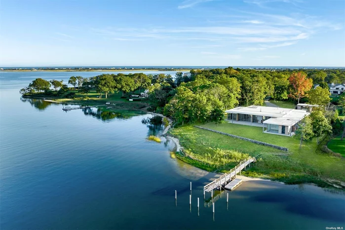 Welcome to 27 Bay Road. Enjoy high-end modern design, easy single-level living and stunning waterfront views in this just completed new-construction compound featuring a seven-bedroom main residence, pool, spacious cabana and boat dock. This 2.22-acre sanctuary on a protected Quogue Village inlet is perfect for boat lovers. Offering +/- 7, 000 square feet of sleek living space, the main house impresses with chic contemporary style and an open-plan layout that welcomes seamless indoor-outdoor relaxing and entertaining. Thanks to walls of folding glass doors, extraordinary water views greet you the moment you enter the gracious foyer surrounded by sun-splashed dining, living and family rooms. The chef&rsquo;s kitchen and generous dining room make elegant hosting effortless. Outside, expansive patios surround the sparkling pool, while the 500-square-foot cabana offers additional living space and a pool bath. The home&rsquo;s split-bedroom layout begins with a primary suite featuring outdoor access, a sitting room, an oversized walk-in closet and a spectacular spa bathroom with an attached outdoor shower. Across the home, four more bedroom suites with private bathrooms and two more bedrooms with adjoining bathroom provide luxurious accommodations for friends and family. An additional media room, laundry room, two powder rooms, a second outdoor shower, oversized carport and geothermal heat complete this elite offering. This secluded location is less than 2 miles from Quoque Village amenities and ocean beaches. An incredible opportunity awaits in this just completed home.