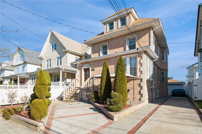 Unparalleled Quality & Elegance converge at this site. Nestled within the prestigious enclave of Rockaway Park, this extraordinary custom built Victorian style home is located mid-block on one of the town&rsquo;s prettiest streets & within minutes of the ocean! Situated on a 40&rsquo; x 100&rsquo; lot size with a detached one and a half car garage & private driveway, one immediately begins to appreciate the serene surroundings & wonderful private yard setting.  The desirable layout offers a mix of vintage charm and modern amenities, lending itself to elegant formal entertaining, as well as casual, comfortable living. Whether you wake up & take in the sunrise from the deck setting overlooking the grounds, or simply cozy up in the living room with a glass of wine by the beautifully designed fireplace after a long days&rsquo; work, this home will certainly feel like the castle you&rsquo;ve always longed for! First Level: You are greeted into a spacious porch, which leads into an extraordinarily welcoming foyer which allows you to enter into the principal duplex unit on the right before heading up to the following secondary duplex unit straight ahead. The first floor opens up into a spacious formal living room with fireplace, followed by a large formal dining room. Exiting from the dining room leads you into a large master en suite with full bath. Towards the rear of this floors&rsquo; unit, there is a grand eat-in-kitchen adjacent to a large pantry setting , as well as a conveniently placed full bath & finally, an access point to the yard, which is as beautiful as it is private. Once coming off the stairs, you enter a lower rear patio setting which is totally enclosed for those wonderful family barbecues which is then further complimented by a rarely found one and a half car garage which can be accessed through the private driveway. Lower Level: The duplex continues allowing for you to enter into a recreation room which grants access to four well sized room settings, in addition to a full bath, laundry room, mechanical room and a seperate outside entrance. Second Level: Proceed upwards to be amazed at the size of the rooms that welcome you in! Beginning with the eat-in-kitchen setting, leading to a large living room, common hall bath,  master en suite with full bath & second bedroom.  Third Level: Upon arriving to this level, the space is split by a conveniently situated full bathroom, whereas you have two exceptionally sized bedrooms on either side. There is also a third room off to one side which can be used as an office & or can be a fifth bedroom The options for design & use are without bounds.  Originally used as a four family, you can grow your family with this use as a two unit structure and in your golden years convert the usage back to a four family rendering additional income when retired. This truly is a forever home! Don&rsquo;t miss out on owning this extraordinary home in both location & design! The potential to make it your own is priceless. Special Features: One & a Half Car Garage                   Wonderful Private Yard Hardwood Floors Throughout               Minutes to the Beach Original Detail Throughout                  Living Room with Fireplace
