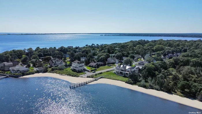 Architectural masterpiece situated on 175&rsquo; of private sandy beachfront on the south side of the peaceful Shinnecock Bay. Experience this custom built in 2019 waterfront gem which sits on 0.76 acres offering an expansive 175 of water frontage and a new 136&rsquo; dock. The magnificent open concept residence boasts 5, 586 square feet home which brings functionality, versatility and luxury together. The inside wonderfully connected to the outside has a brand new infinity edge pool and spa, custom copper chimney, mahogany deck with custom cable railing system and the blue stone veranda is steps from its own private beach. An impressive property with 5 bedrooms, 5 bathrooms and 2 half baths as well as a 2 car garage. Take in breathtaking panoramic water views from almost every window, an eastern facing property to allow for morning sunrise. Enjoy water activities from your private dock and beach and conveniently located south of the highway close to world class restaurants. Limited availability for summer!