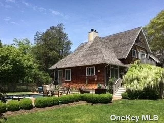 Near Village of East Quogue with Heated Pool. This inviting arts and crafts home features plenty of light-filled living space including a living room and den with vaulted ceilings, dining room, three bedrooms, four bathrooms, and office, all surrounded by mahogany decking and balconies. There is a finished basement with a large entertainment area, pool/ping pong table, bathroom, and outside access. After an afternoon at the beach or kayaking on the bay around the corner, relax by the heated gunite pool surrounded by lush landscaping. Located on a quiet street within walking distance to the Village of East Quogue restaurants, shops, concerts in the park, and jitney stop. This meticulously maintained home offers an opportunity to enjoy a memorable summer vacation full of activities, entertainment, and relaxation. NOTE: Available for three weeks, August 1st through August 21st for $22, 500, or two weeks for $9000/wk