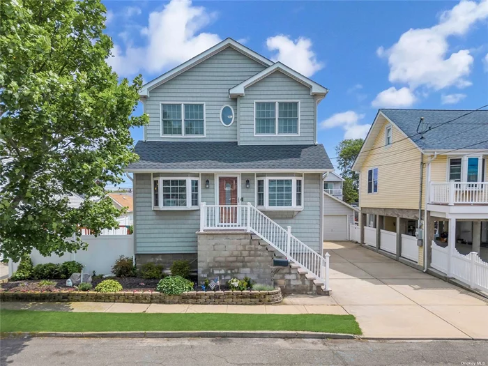 This Lindenhurst waterfront home was renovated in 2017 to provide comfort, style and functionality. The main living area has a spacious and open concept design complete with radiant heat combining the living room, kitchen and dining area seamlessly making it great for entertaining. The updated kitchen is equipped with high end Viking stainless steel appliances and ample counter space for food preparation. The primary bedroom is generously sized with two walk in closets allowing room for a sitting area if desired. The remaining three bedrooms are equally inviting with ample closet space and large windows which allow for plenty of natural light. You can enjoy the tranquility of a waterfront location from your upper deck which leads to your private dock allowing for easy access to boating, fishing and other water activities. A must see....