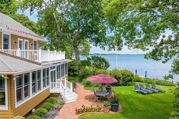 This lovingly restored 1902 shingle-style beach house on the Peconic Bay is a great place to relax, and enjoy the beauty of the North Fork. Step back into an era of gracious living, with all the amenities of modern life. Boasting incredible southern views, bay breezes, and generous proportions, this beautiful home is sure to exceed your expectations. The four bedrooms in the main house, two with balconies overlooking the Bay, provide plenty of space for your family and guests. And if you need a little extra room, the separate cottage is sure to come in handy. Some of the original features include high ceilings, tall windows, and hardwood flooring. The sunny, updated kitchen has a large center island, leading to a generous formal dining space. Open to the generous living room with wood-burning fireplace, your gaze is drawn towards the water views and the fully enclosed sun porch for lounging, dining and entertaining. A den/study on the first floor is complete with built-in bookcases and cabinetry, and the first floor bath has both a claw-footed tub and walk-in shower. With 106&rsquo; of waterfront, the double bulkheading allows for a private beach area and (bonus!) winch to help you get your water toys in and out of the bay. This charming historic retreat is close to shopping, farmstands, and vineyards. Breathe deep and relax.