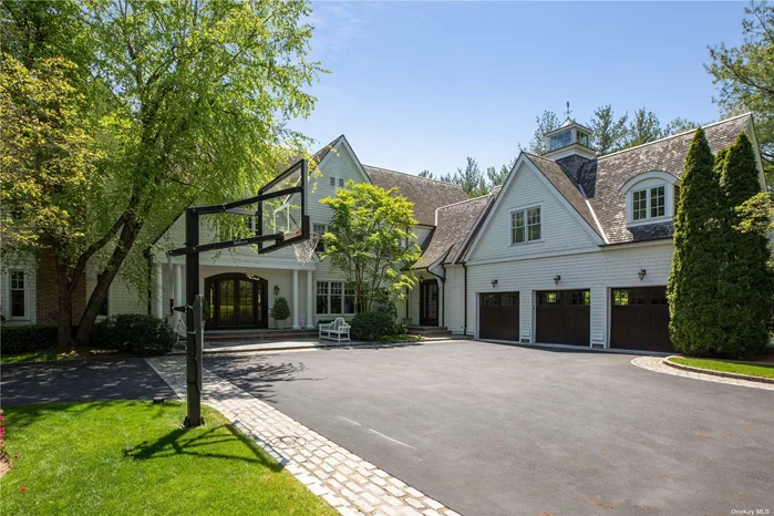 This custom built Hampton-style colonial unfolds on over 2 acres of sprawling manicured grounds in the prestigious Village of Sands Point. The property boasts an in-ground swimming pool, a cabana with wet-bar, outdoor kitchen and a spacious full bathroom. The 7, 700+ square foot home boasts 6 bedrooms, 8 bathrooms, high ceilings throughout, top-of-the-line appliances and an abundance of natural light. The custom wood flooring, fully stocked wet-bar, circular breakfast nook surrounded by windows and the oversized family room with a spectacular barreled ceiling drive home the architectural integrity & hand craftsmanship that went into constructing this one-of-a-kind residence.