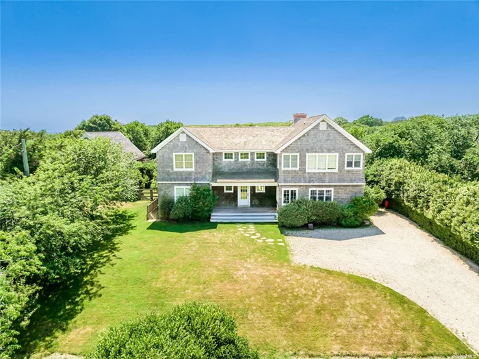 Ocean Breeze-Ditch Plains-Montauk Stylish and inviting 5 bedroom home on just under a half acre with a pool and gated entrance in the desirable Ditch Plains area of Montauk. A charming covered porch opens to the first floor delivering a double height entry foyer, an open living area with fireplace, a dining area, a country eat-in-kitchen, 2 guest bedrooms that share a bath, a powder room, a laundry room and a fabulous porch area perfect for lounging. The second floor offers a stunning primary bedroom with vaulted ceiling, an en-suite bath, and a private balcony with an outdoor shower. In addition, there are 2 additional guest bedrooms that share a bath, a lounge area and a workout room. Once outside, enjoy the lazy days of summer while lounging by your pool. The outdoor shower is available for a quick rinse after the beach and offers a door for quick access the laundry room. A rare find in a premier location. The ocean is calling!