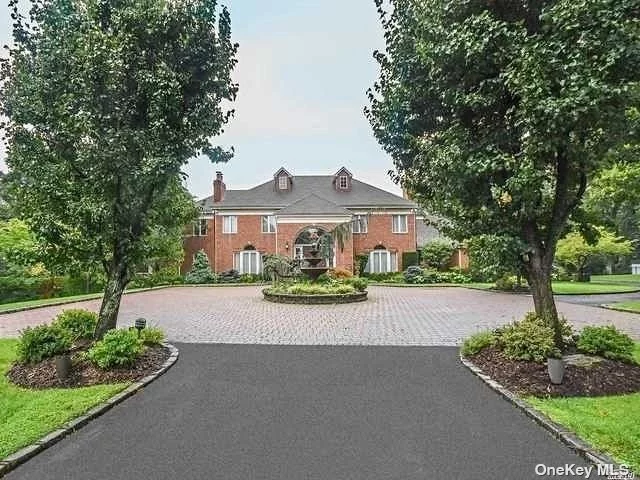 Step into luxury with this stately yet inviting brick colonial, meticulously maintained and offering country club-style living on a sprawling property just shy of 5 acres. Nestled at the end of a charming cul-de-sac, this residence welcomes you with a grand circular driveway. The attention to detail is simply stunning, from custom-made moldings to elegant fireplaces. With a generous 6800 sq ft of living space, this home is not just about living; it&rsquo;s an unparalleled experience. The highest quality of construction is evident throughout, and the master shower, a steam shower, adds an extra touch of luxury. The basement&rsquo;s walk-out feature seamlessly connects indoor and outdoor spaces, allowing you to enjoy the beauty of the property at every turn.  Discover the enchanting features of this property, including a stunning koi pond that adds a touch of serenity to the landscape. The grounds are adorned with special specimen trees, including over 5 Japanese maple trees, enhancing the natural beauty of the surroundings. This smart home offers modern convenience with seamless control over the pool, sprinkler system, lights, and more. Enjoy the peace of mind provided by a whole-house generator and water filter. Indulge in wellness with a 10-person sauna and a fully equipped gym. For those who love to entertain, this is a dream come true, featuring 1200 sq ft of bluestone patio and outdoor spaces. Step into the outdoor oasis and dive into elegance with a saltwater gunite pool, measuring an impressive 20x40, complemented by an attached oversized hot tub. The pool and hot tub are heated by a rather new propane heater, ensuring year-round comfort. The property is truly a must-see, promising a lifestyle of opulence and comfort. Schedule your visit today and experience the epitome of refined, country club-style living!