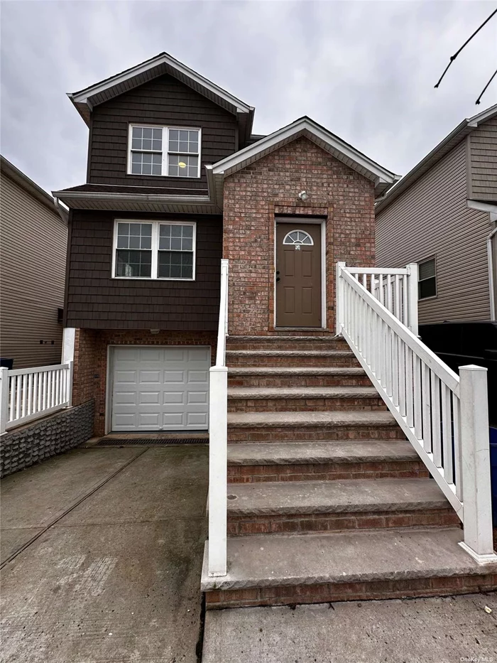 Staten Island Two-Family Colonial Townhouse With 4 Bedrooms and 3.5 Bathrooms. Large backyard, private driveway, attached 1-car garage. HOA FEE $77