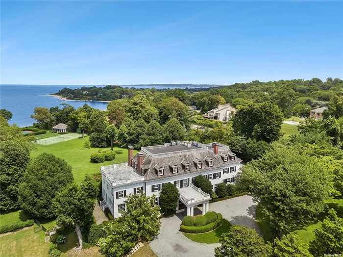 Spectacular unfurnished estate. Experience timeless elegance at The Lindens, a gracious estate nestled on 5.86 acres of meticulously landscaped Long Island Sound waterfront. With 187 feet of sandy beachfront and breathtaking water vistas, this distinguished residence, built in 1910, boasts 13 bedrooms and 8.55 baths. Meticulously preserved, this home exudes charm with its period details and timeless design. Surrounding the expansive bluestone terrace, perennial plantings add bursts of color, complementing the endless water views. Enjoy leisurely days by the sparkling swimming pool or on the all-weather tennis court, seamlessly integrated into the enchanting gardens. A charming cabana, featuring a columned covered front porch adorned with exquisite woodwork, adds to the picturesque allure. Conveniently located just 25 miles east of Manhattan, The Lindens provides easy access to both Grand Central and Penn Station via direct train lines. Moreover, indulge in fine dining and upscale shopping at the nearby Americana Shopping Center, mere minutes away. Experience the epitome of waterfront living and sophisticated leisure at The Lindens.